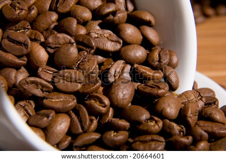 Cup with coffee grain, costing on coffee grain