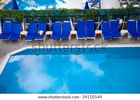 Swimming  pool with chaise-longue in hotel
