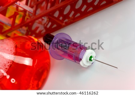 close up of syringe with sample in test tube close up of syringe with sample in test tube
