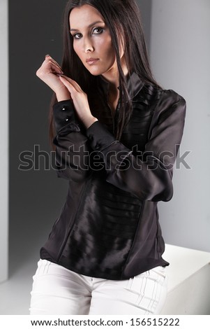 Portrait of sexy brunette in sheer black blouse