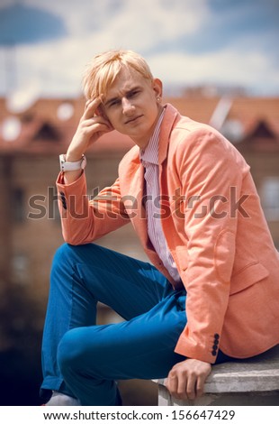 Handsome man sitting on rooftop