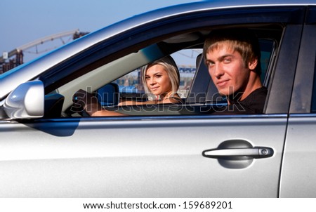 Handsome man sitting and car. Can see sexy driver  woman through open window of his car