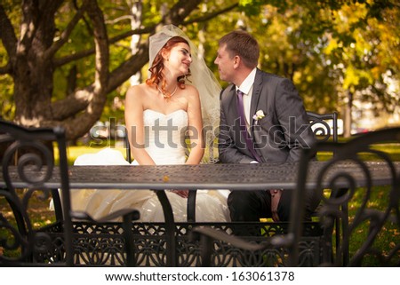 Beautiful smiling newly married couple talking on summer terrace