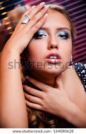 Closeup portrait of sexy luxury woman holding hand on head and neck