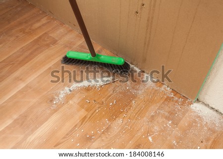 Photo of cleaning debris on floor by brush