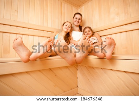 Wide angle photo of mother and daughters feet at sauna