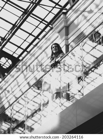Black and white photo of beautiful woman with shopping bag at duty free