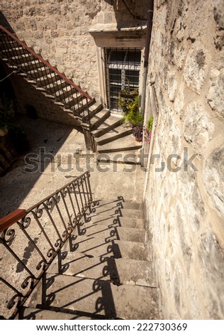Old stone double staircase at backyard of ancient house
