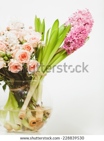 Closeup shot of different flowers standing in glass vase