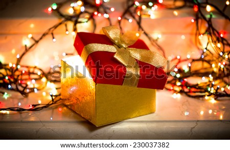 Closeup photo of open gift box with light coming out of it