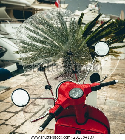 Closeup photo of red scooter bike got wet in rain