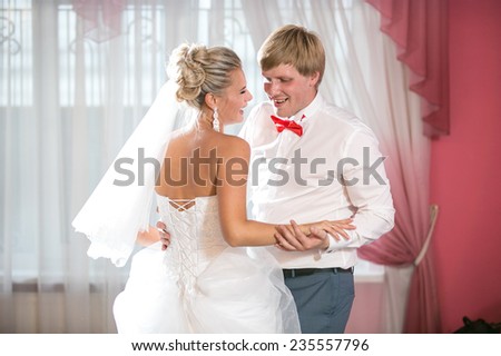 Portrait of beautiful bride and groom dancing at restaurant