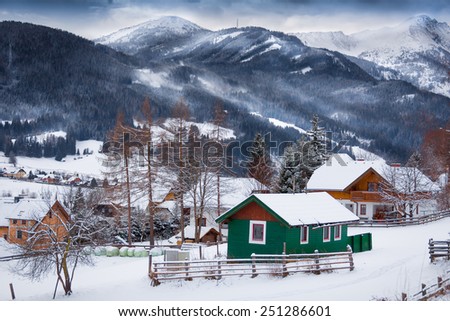 Beautiful landscape of traditional wooden houses on high mountains covered by snow
