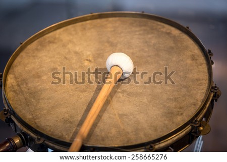 Closeup photo of old war drum with drumstick
