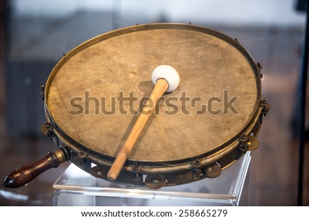 Closeup photo of old war tambourine with drumstick