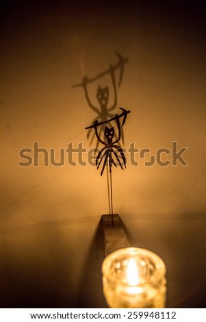 Closeup photo of  scary shadow of demon on wall