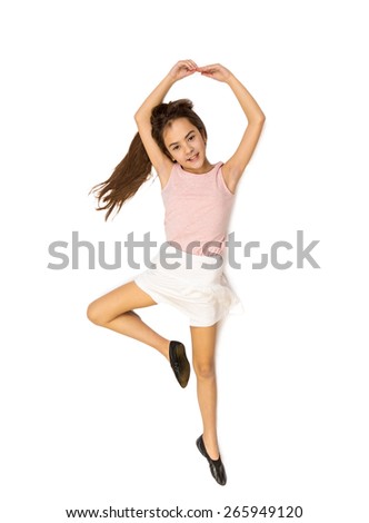 Isolated photo from high point view of cute girl lying on floor and pretending to dance ballet