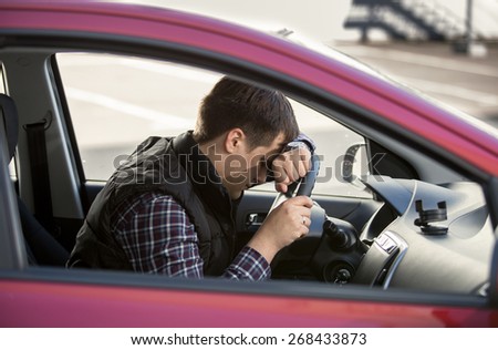 Closeup portrait of upset man holding steering wheel