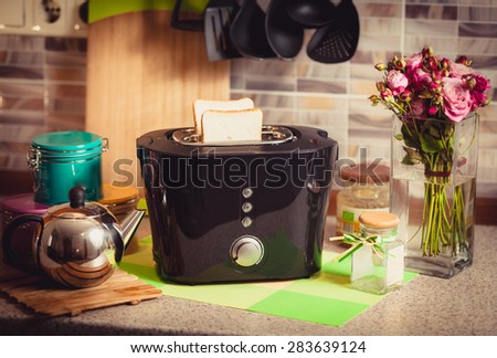 Toned shot of toaster with fresh brad on beautiful decorated kitchen
