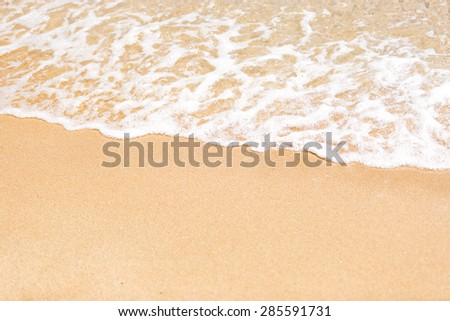 Closeup shot of sea wave rolling on the sand