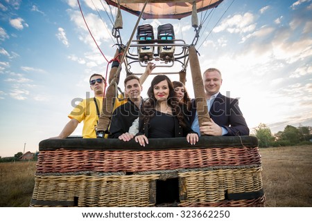 Happy group of people posing in hot air balloon basket