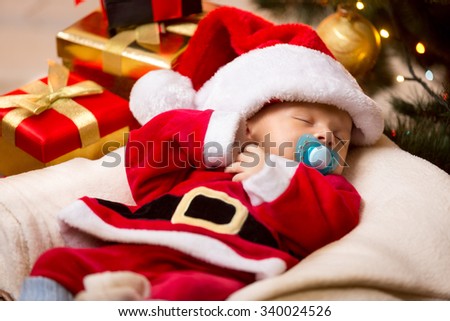 Cute newborn baby sleeping in white and red Santa Claus costume