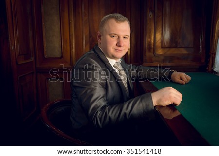 Portrait of man in vintage suit posing in banker office