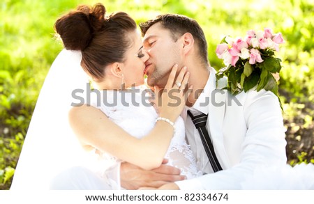 Portrait of newly married couple hot kiss
