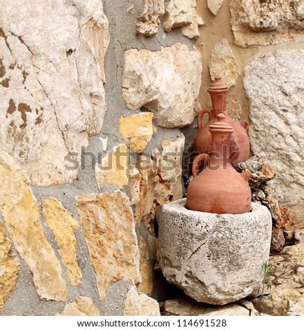 Two traditional clay jars from Lebanon on a stone background.