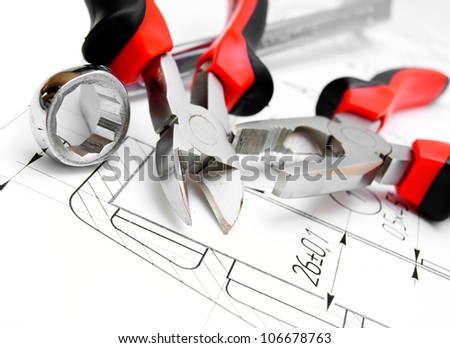 The drawing and tools (flat-nose pliers, a wrench).