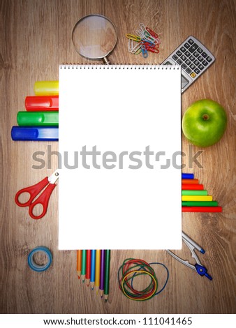 Back to school. School accessories on a wooden background.