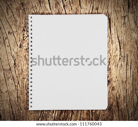 Notebook on a wooden background.