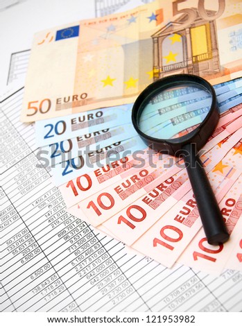Magnifiers and denomination euro on documents.