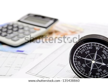 Compass, money and the calculator on documents.