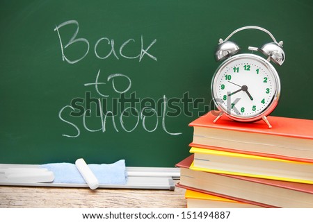 Alarm clock on books. Against a school board. Back to school.