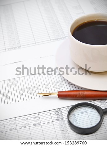 Coffee and pen on the documents.