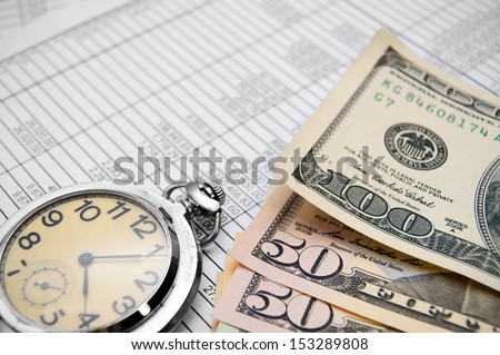 Watch and dollars on documents.