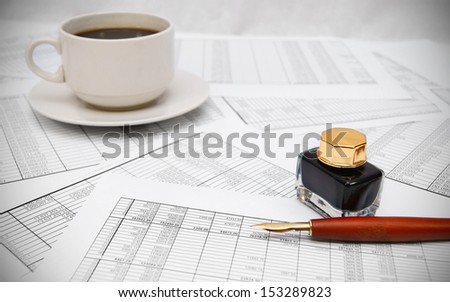 Coffee and pen on the documents.
