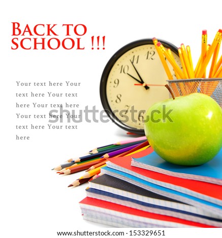 Back to school. Watch and an apple with writing-books on a white background.