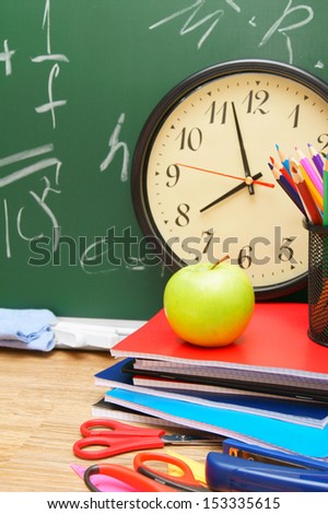 Watch and school accessories against a school board.