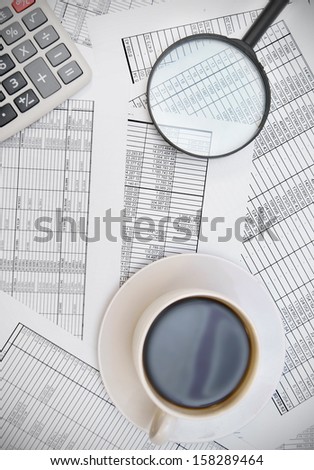 Coffee, the calculator and magnifier on documents.