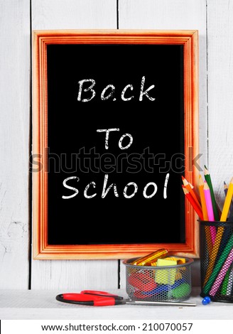 Back to school. Frame. School tools on a wooden shelf.