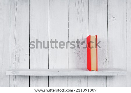 Book on a wooden shelf. On a wooden, white background.