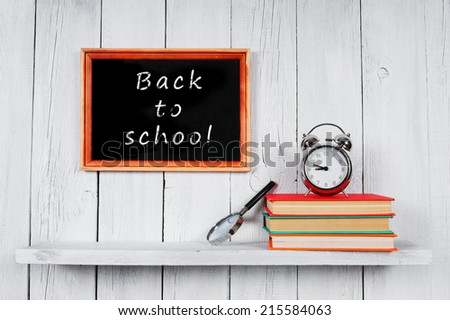 Back to school. Frame. Books and school tools on a wooden shelf.