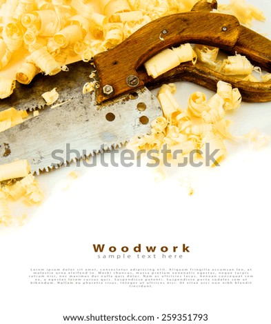Woodworking. Joiner's works. Wooden shaving and saw on white background.