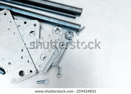 Metal working tools. Metal style. Metal preparations and fixing elements on the scratched metal background.