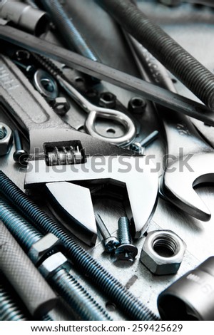 Metal tools. Metal style. Wrench and metal tools on the scratched metal background.