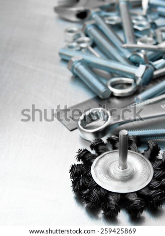 Metal tools. Metal style. Grinding circle and other tools on the scratched metal background.