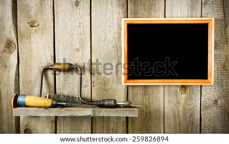 Old working tools. Many old tools and frame on a wooden background.