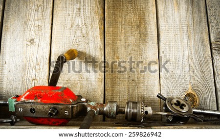 Old working tools. Many old tools ( drill, pliers and others) on a wooden shelf.
